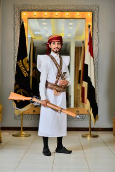 Man in traditional Yemeni clothing holding a rifle in Taizz, Yemen