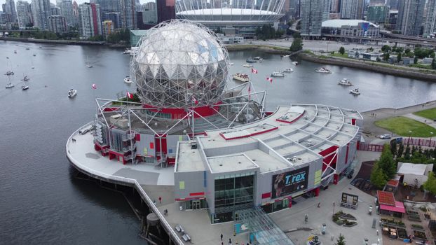 Aerial shot of Science World in Vancouver with Domo geodesic dome and cityscape background.