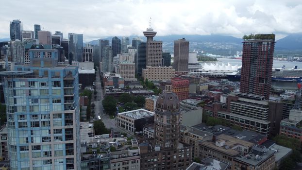 Captivating aerial shot of Vancouver skyline with Canada Place and mountains.