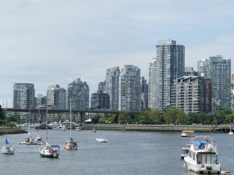 Scenic view of Vancouver skyline and boats on False Creek, captured on a sunny day.