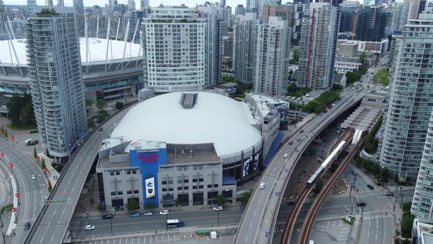 Explore the bustling skyline of Vancouver with Rogers Arena in the foreground.