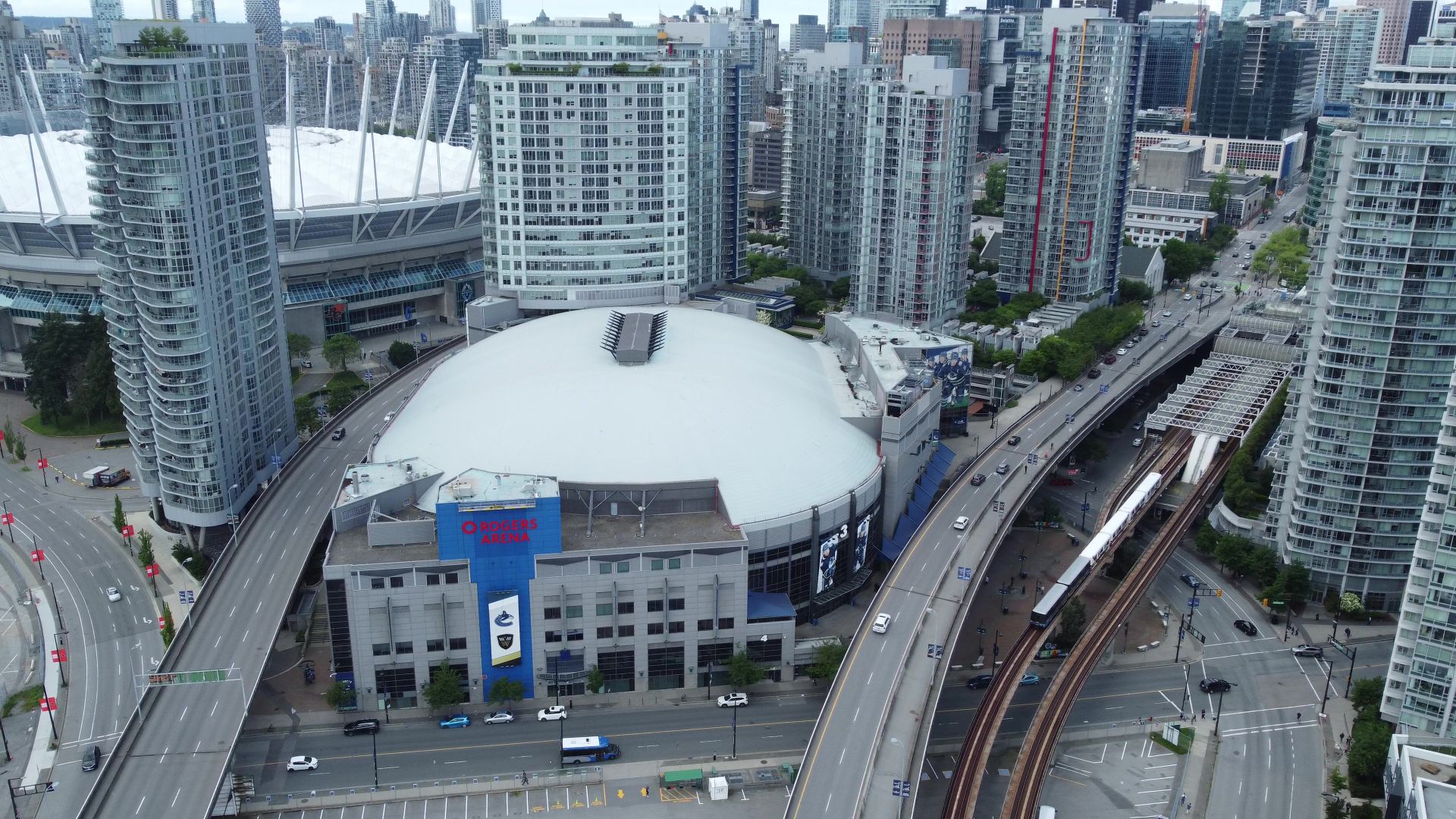 Explore the bustling skyline of Vancouver with Rogers Arena in the foreground.