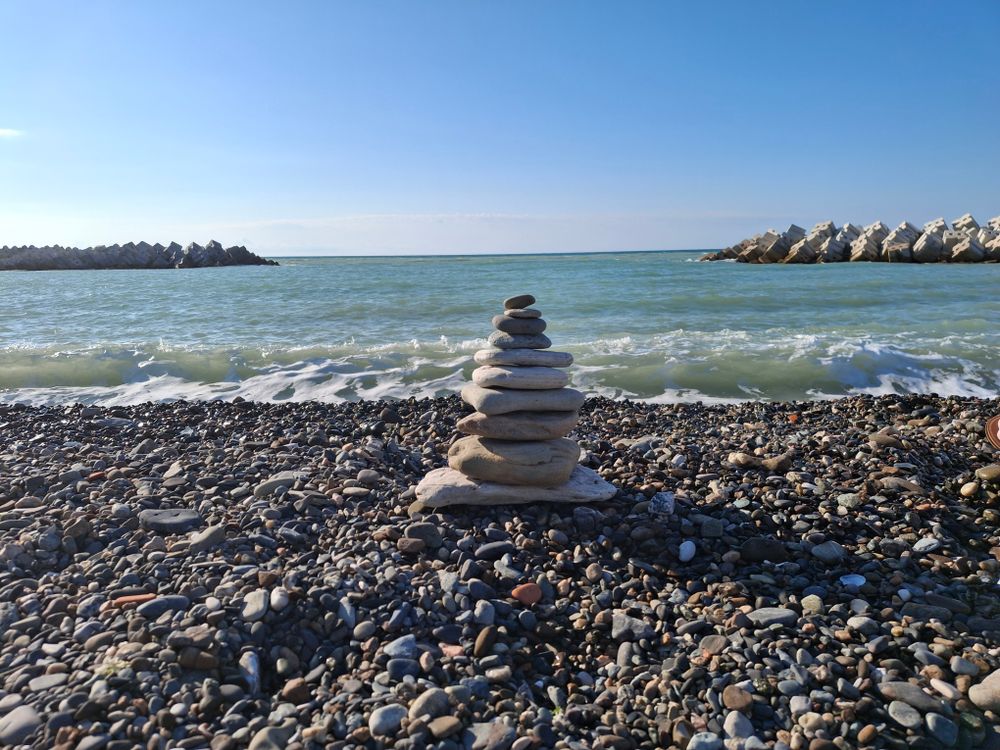 Peaceful Pebble Stack on a Rocky Beach Shore · Free Stock Photo