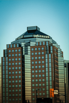 Stunning view of Telus building in Toronto with a clear sky background at dusk.