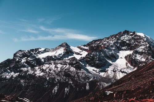 Free Stunning view of snow-covered mountains under a clear blue sky, showcasing winter's beauty. Stock Photo