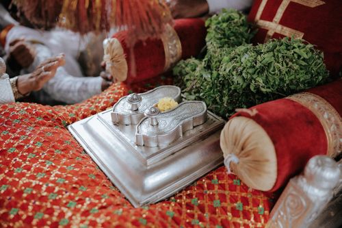 Free A close-up of a ceremonial setup with silver padukas and decorations in an Indian cultural ceremony. Stock Photo