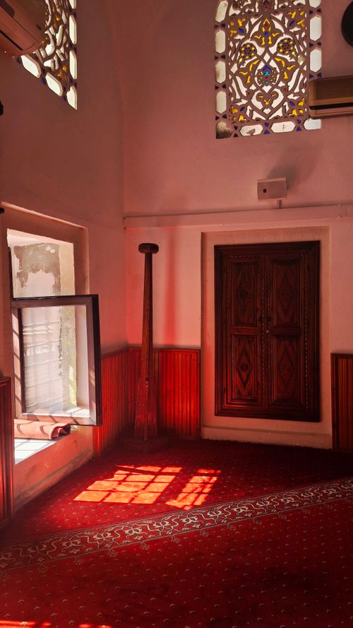 Free Warm interior with intricate windows and sunlit carpet, exuding traditional charm. Stock Photo