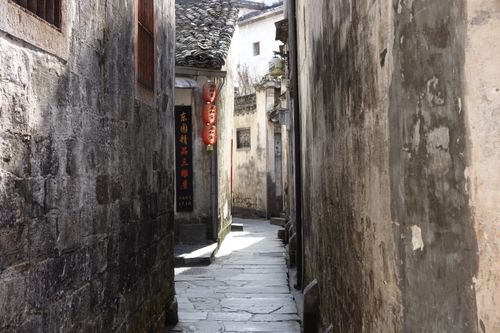 Free Explore an ancient alley in a traditional Chinese village, showcasing rustic architecture and lanterns. Stock Photo