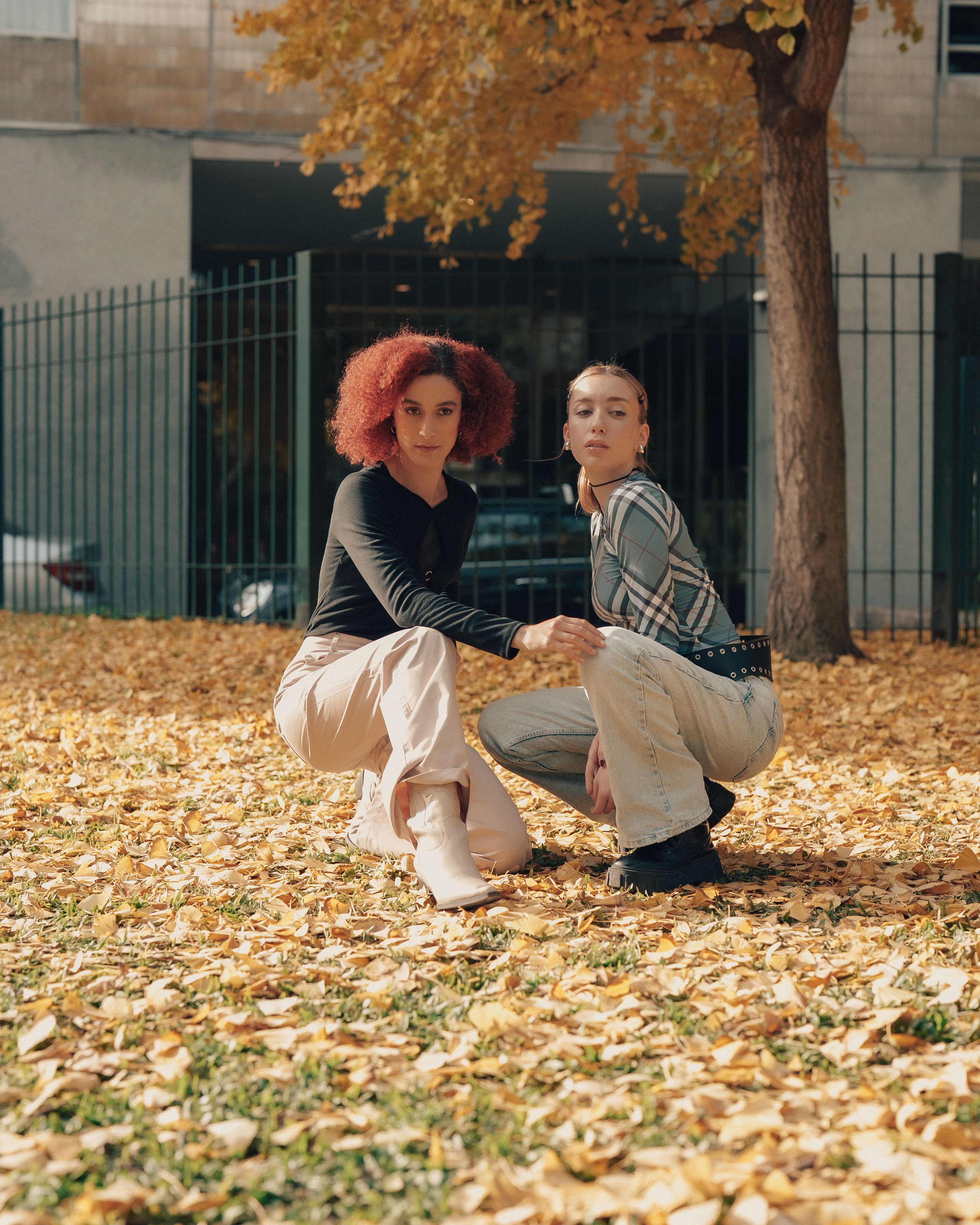Two Women Posing Outdoors in Autumn Leaves · Free Stock Photo