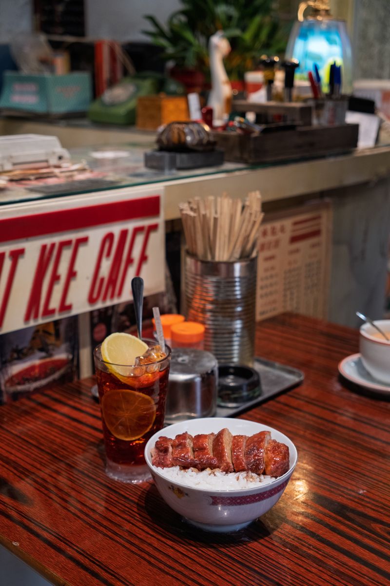 Classic Hong Kong cafe with dish and drink, capturing authentic dining ambiance.