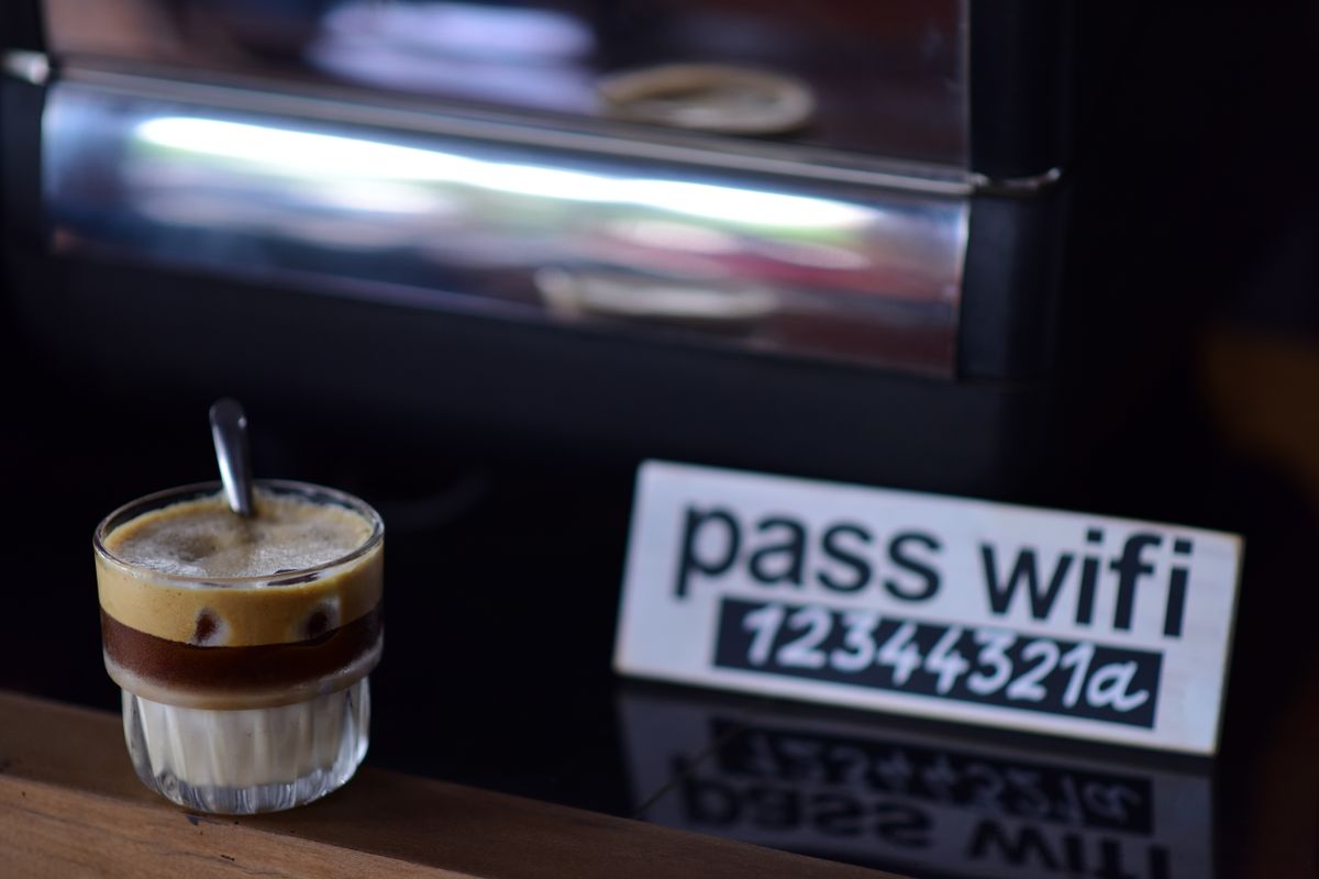 Masa de cafenea cu o placuta pe care e scrisa parola de wifi