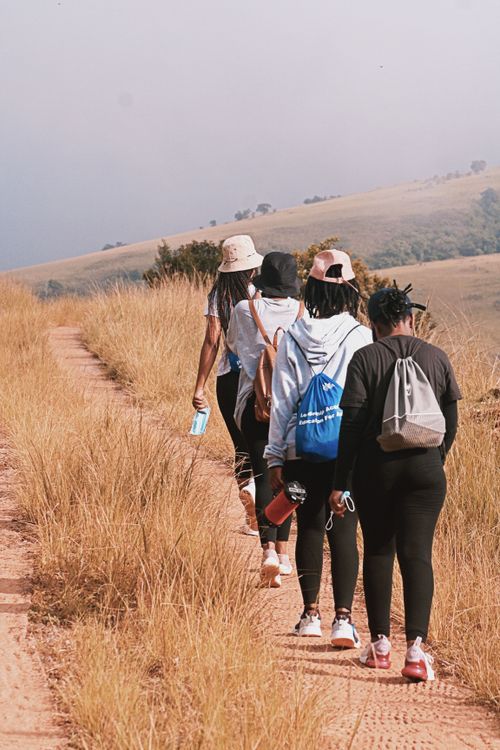 Free Group of hikers walking along a scenic trail in Mbabane, Eswatini, showcasing natural beauty and adventure. Stock Photo