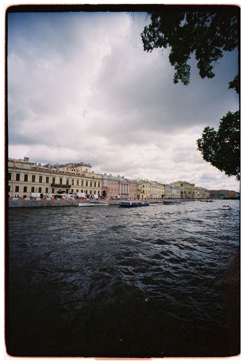 Free Picturesque view of colorful historic buildings lining the Neva River in St. Petersburg, Russia. Stock Photo