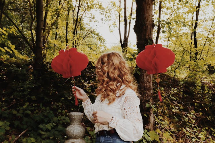 Woman With Red Paper Lanterns In Autumn Park