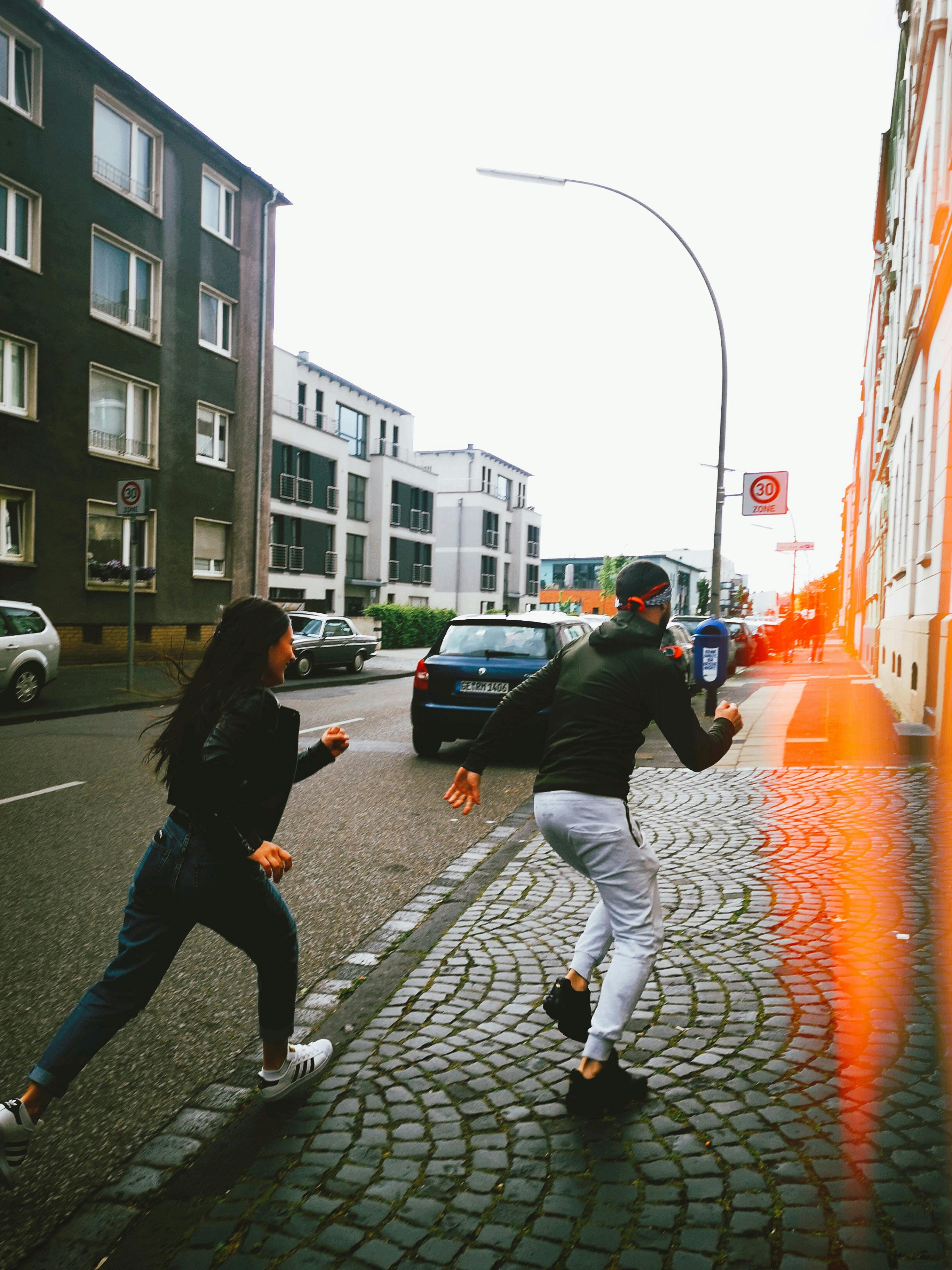 man and woman running outdoors