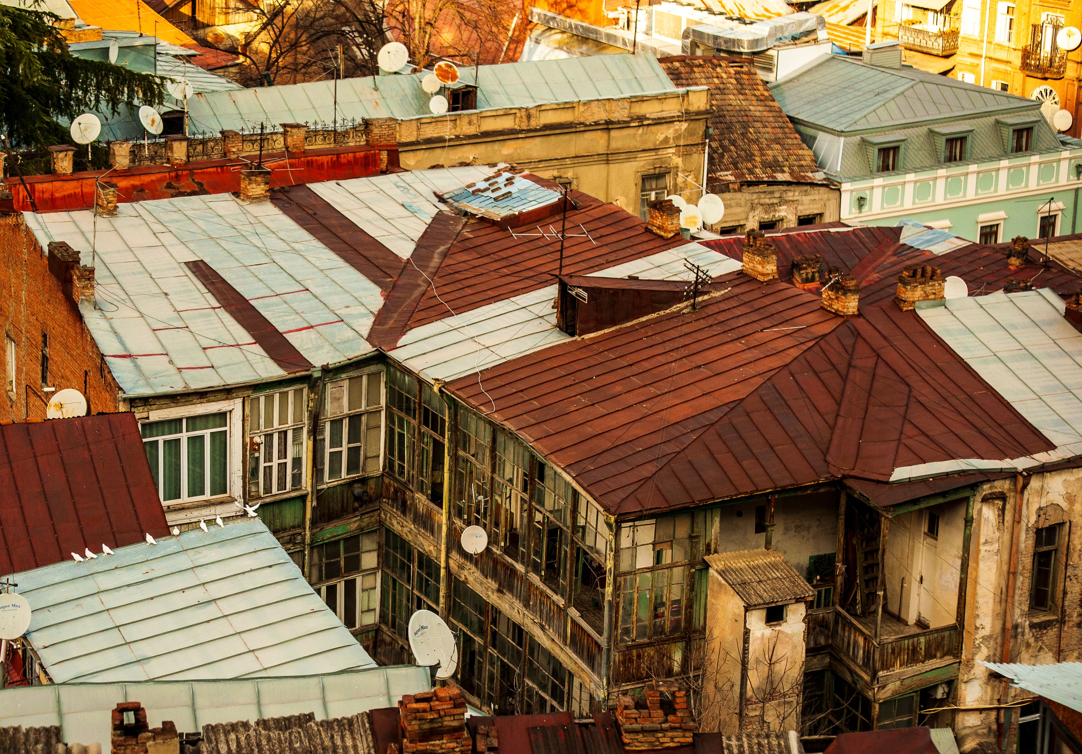 Aerial View of Rustic Rooftops with Satellite Dishes · Free Stock Photo