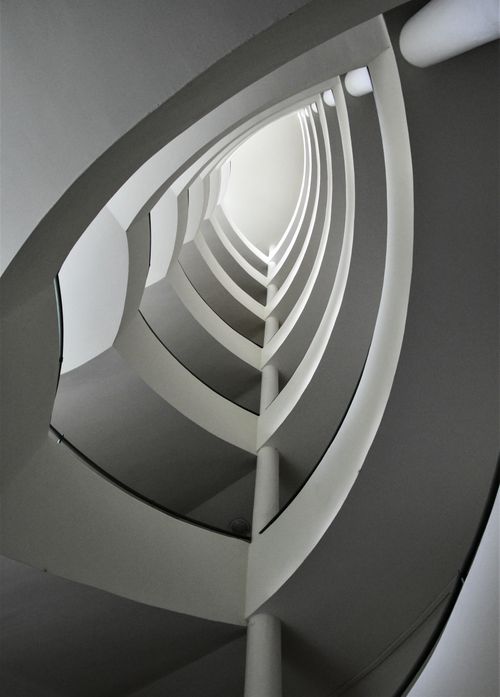 Free A modern spiraling staircase design captured from below in Budapest, Hungary. Stock Photo
