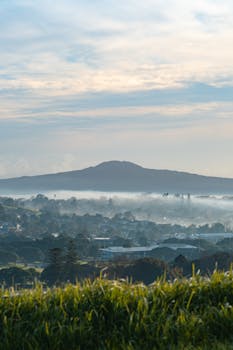 Serene foggy morning view over the cityscape, with distant hills in New Zealand.