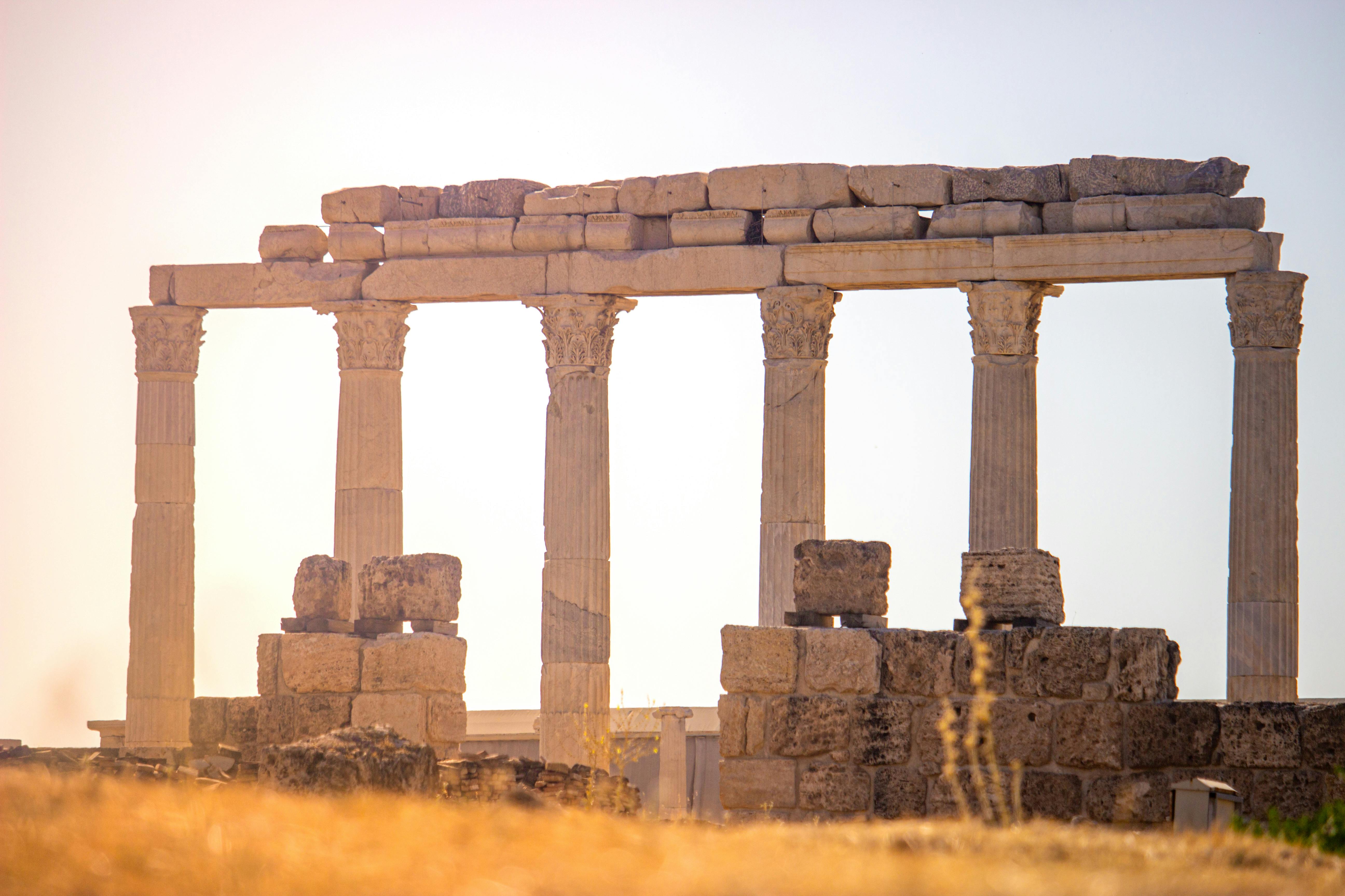 Majestic ancient Greek ruins with columns captured at sunset, exuding historical charm.