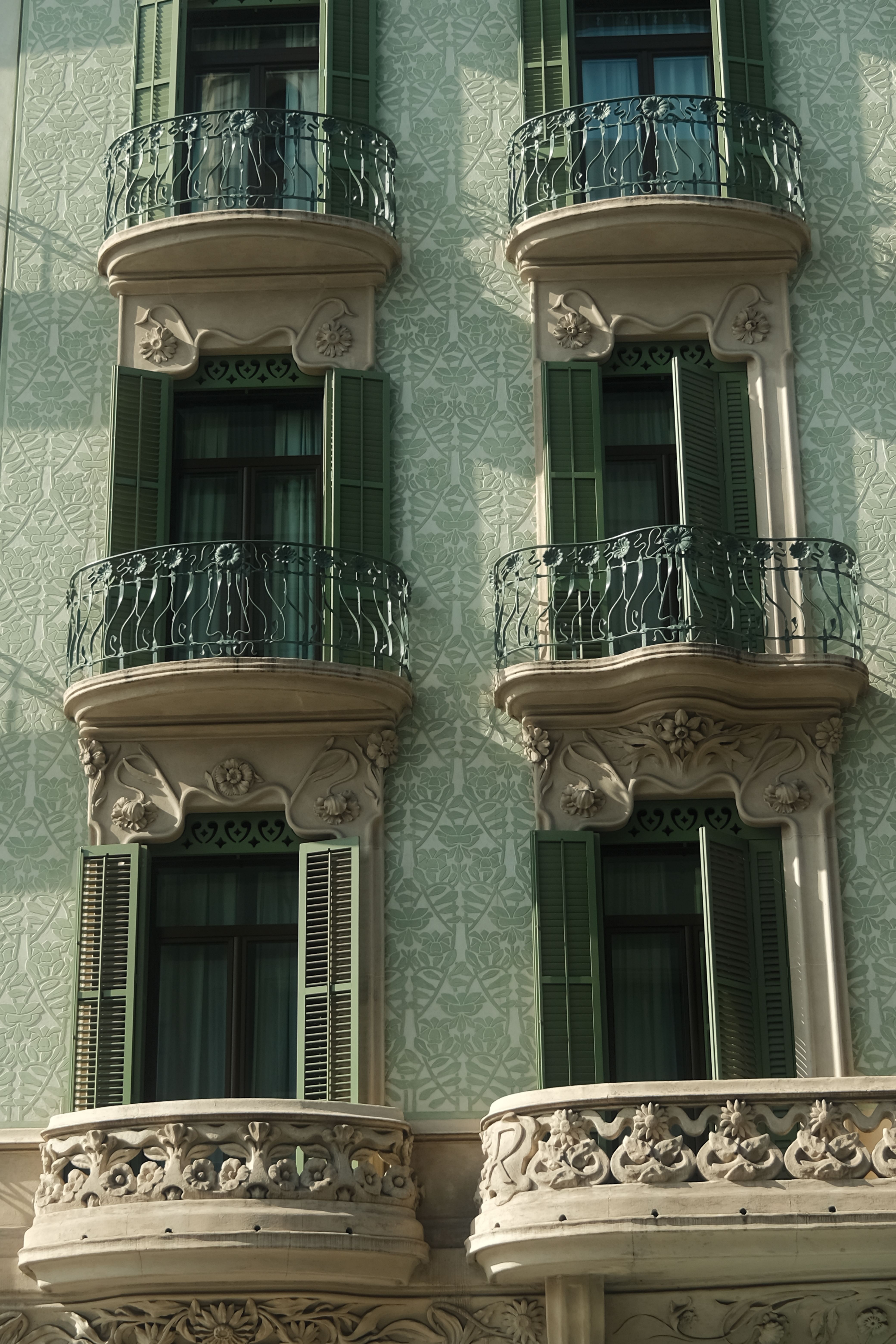 Close-up of an intricate European building's balconies, showcasing classic vintage architecture.