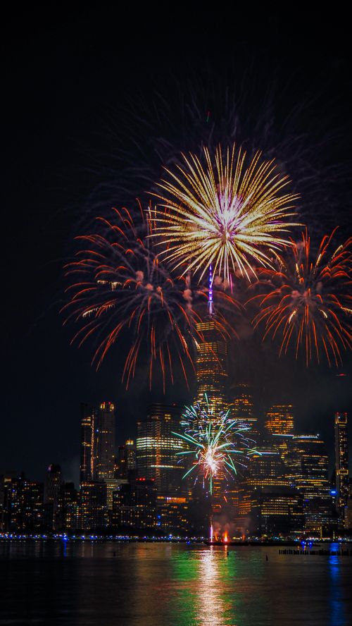 Free Spectacular fireworks illuminate the night sky above the One World Trade Center in New York City. Stock Photo