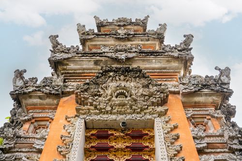 Free Close-up of a detailed Balinese temple featuring ornate carvings and decorations under a clear sky. Stock Photo