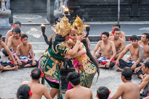 Free Traditional Balinese dance performance with detailed costumes and attentive audience at an outdoor ceremony. Stock Photo