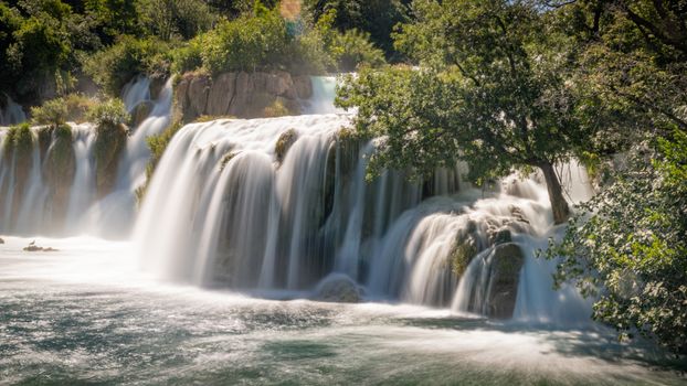 Stunning waterfalls cascade in Krka National Park, Croatia, showcasing nature's beauty.