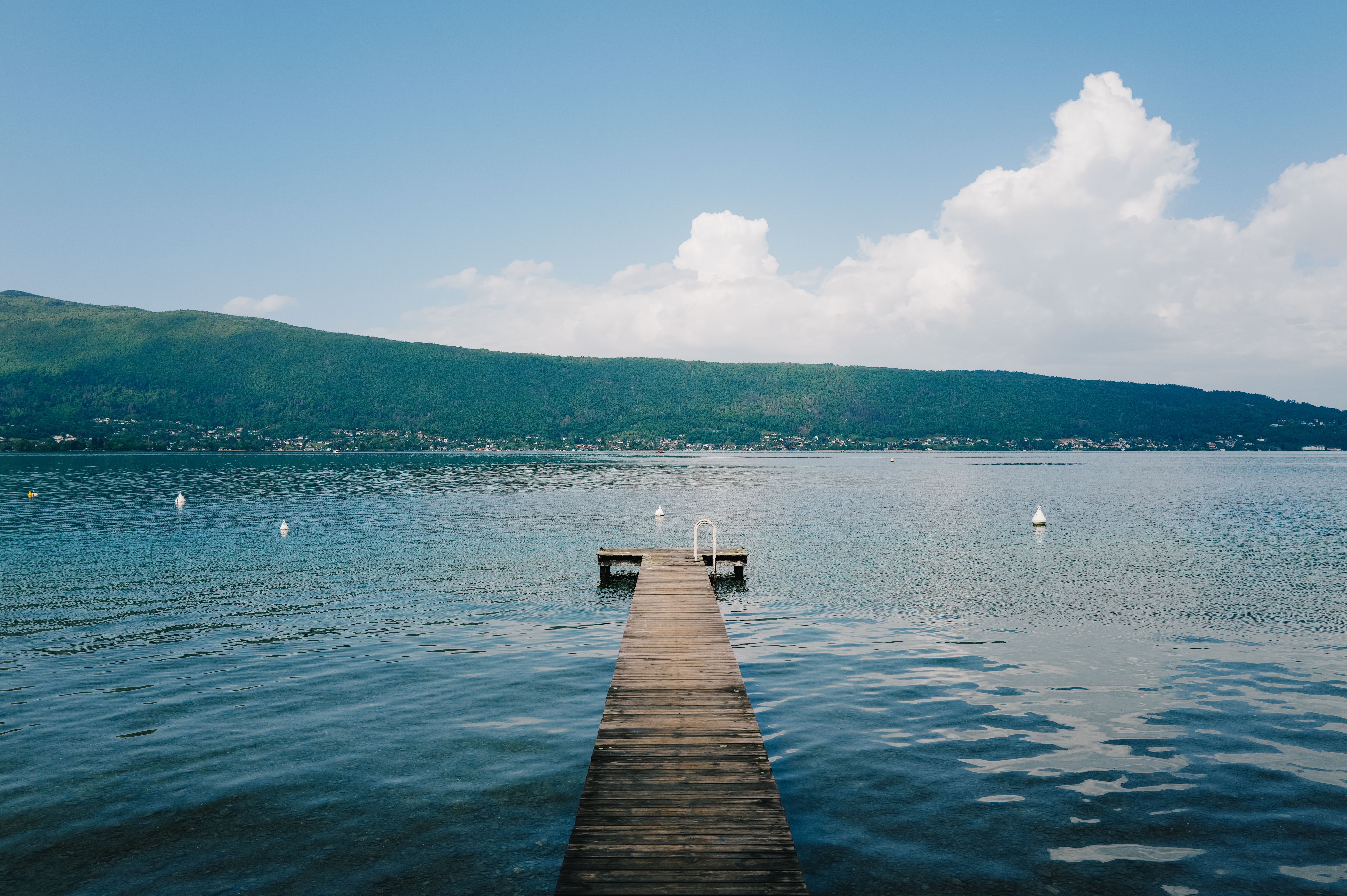 Serene Lakeside Dock View Under Blue Sky · Free Stock Photo
