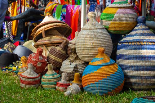 Free Brightly colored woven baskets displayed at a lively market in The Gambia. Stock Photo