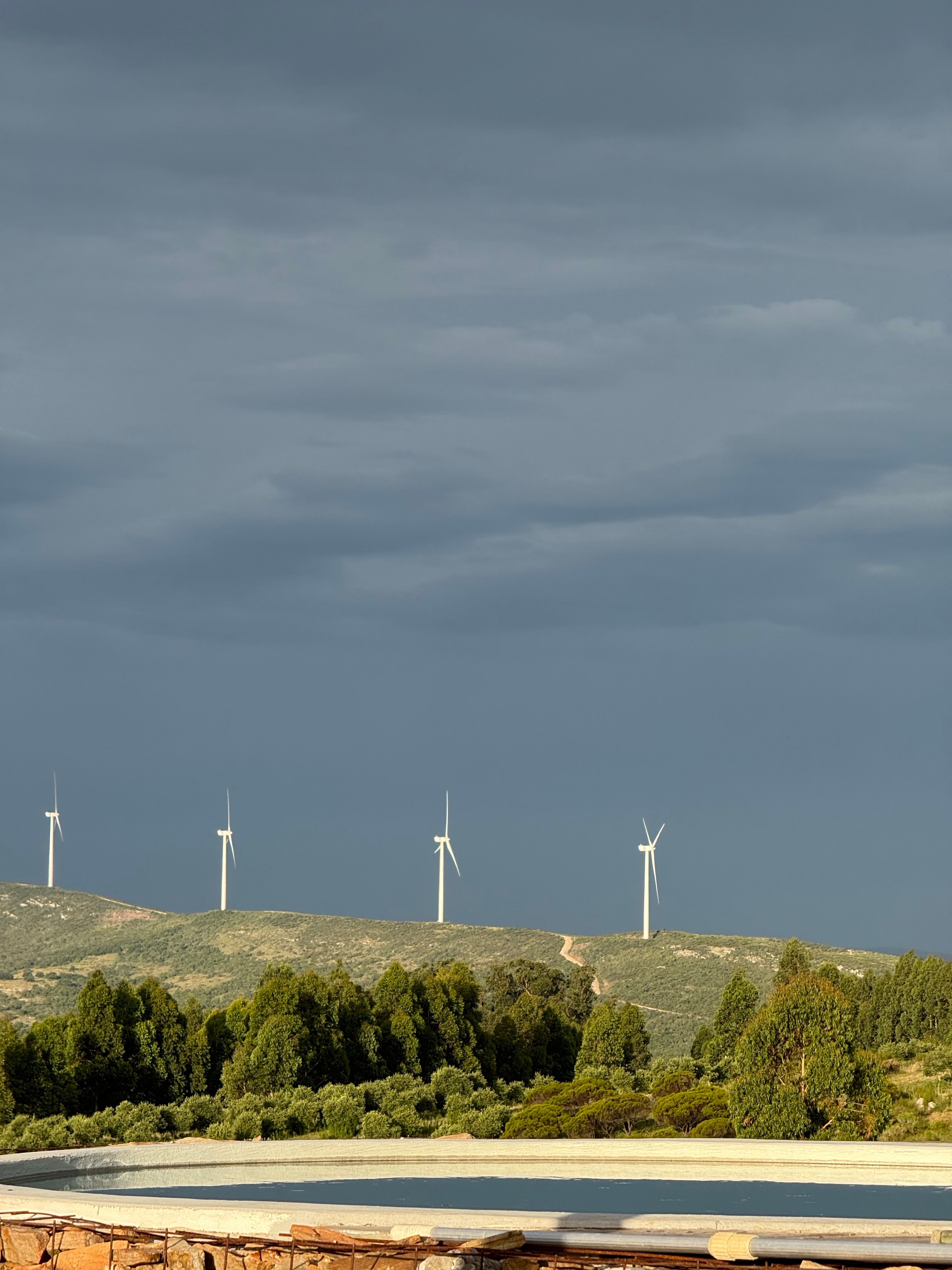 Wind Turbines on Green Hills Under Moody Sky · Free Stock Photo