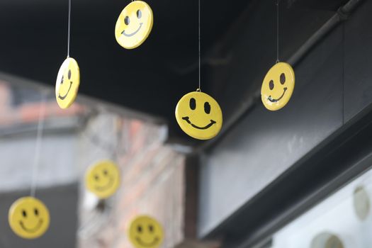 Cheerful yellow smiley faces hanging outside, creating a joyful atmosphere.