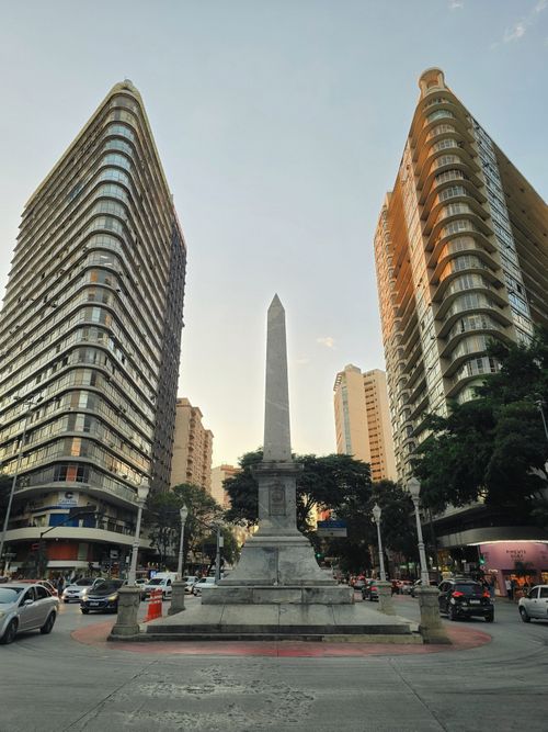 Free A striking obelisk between skyscrapers in Belo Horizonte, Brazil, during the day. Stock Photo