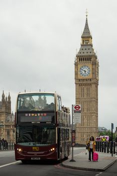 Classic London bus on Westminster Bridge with Big Ben in view.