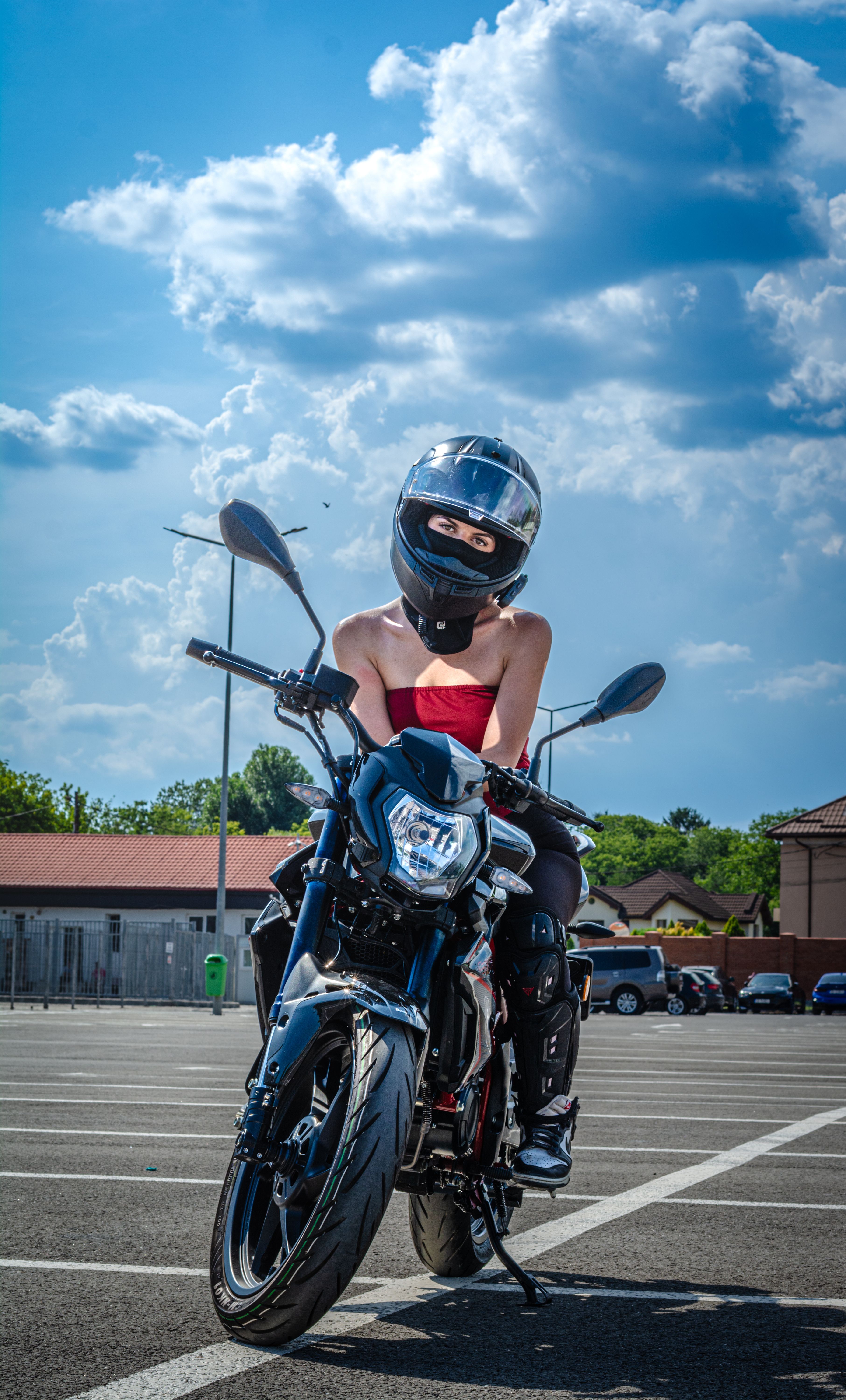 Woman on Motorcycle in Sunny Urban Setting · Free Stock Photo