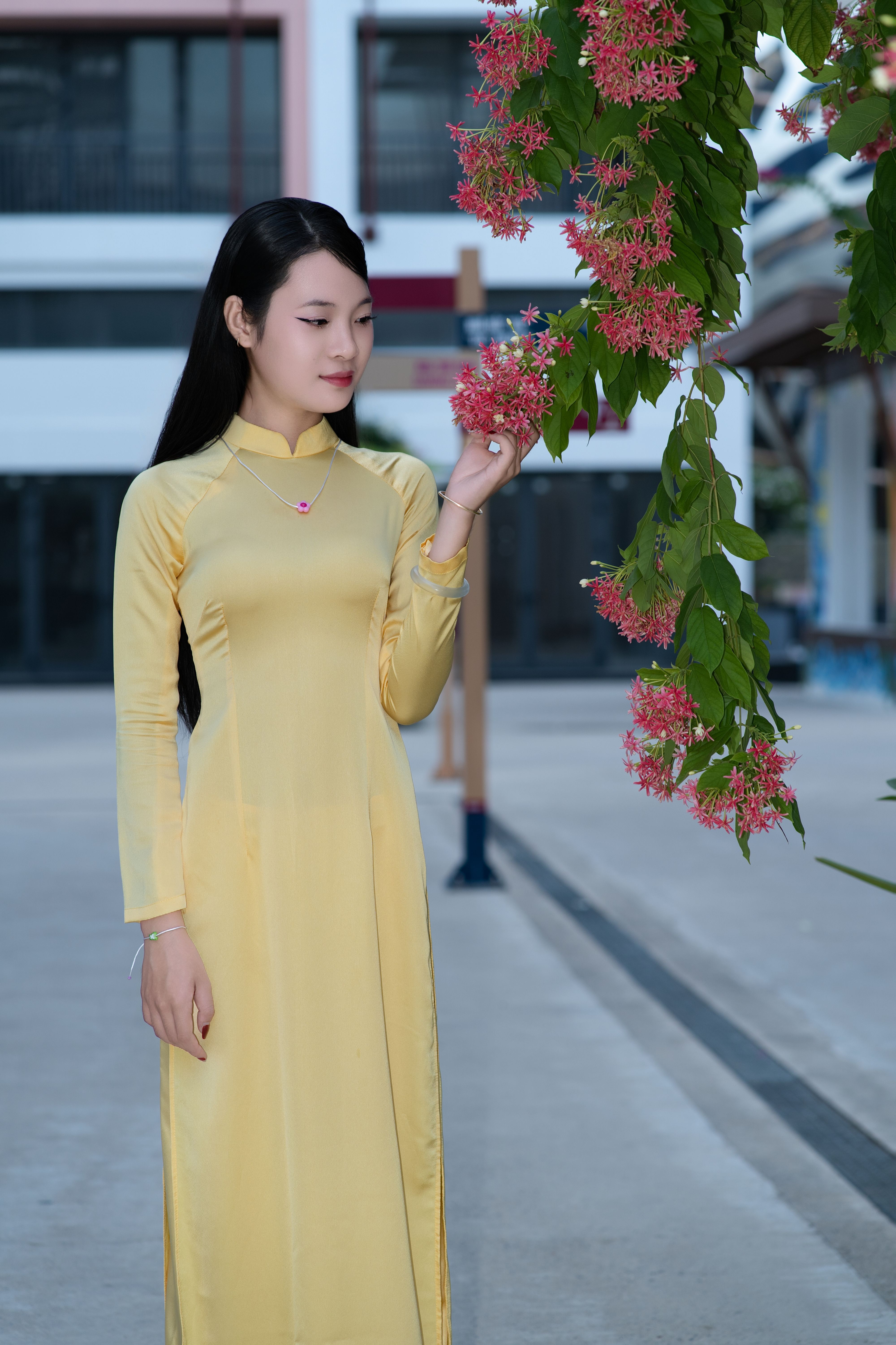 Woman in Yellow Dress with Pink Flowers Outdoors · Free Stock Photo