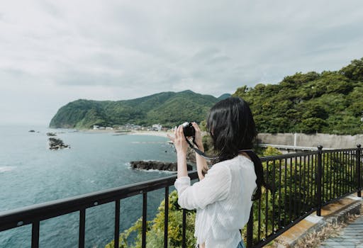 Capture the serene beauty of West Izu Coastline in Japan with lush mountains and ocean views.
