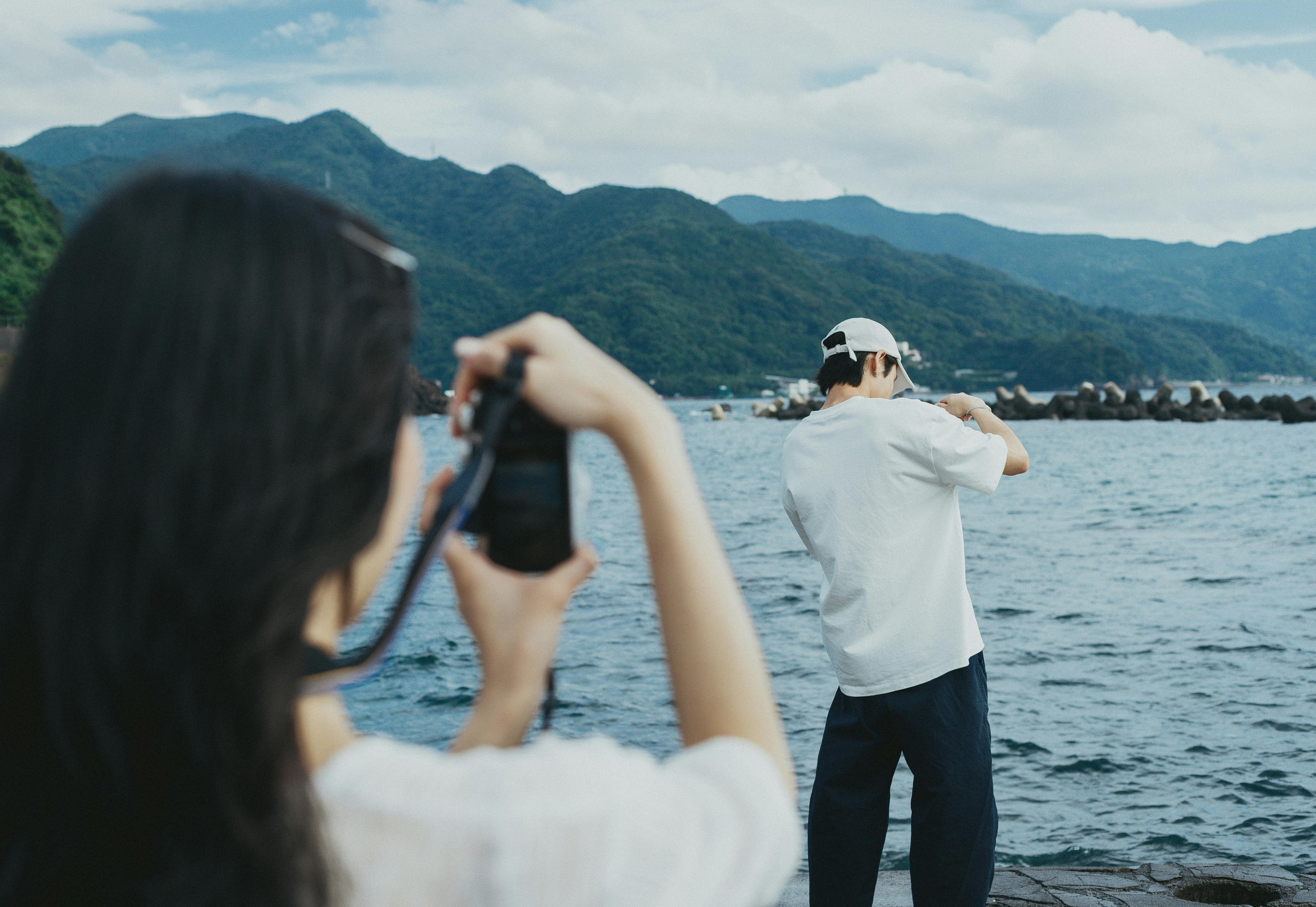 Two people capturing the stunning seaside scenery of Nishiizu, Shizuoka, Japan.