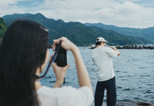 Two people capturing the stunning seaside scenery of Nishiizu, Shizuoka, Japan.