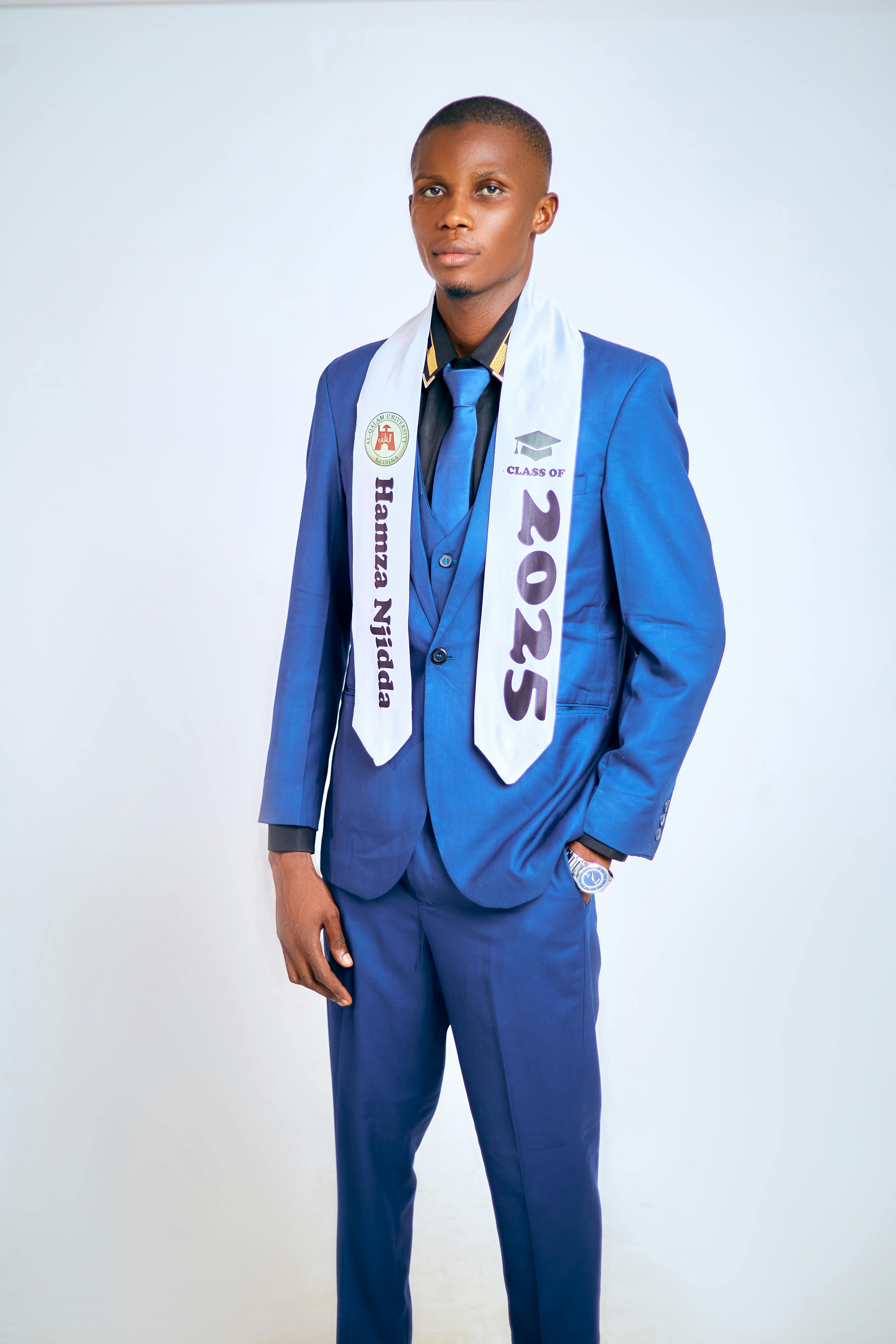 Young man in blue suit with Class of 2025 graduation stole.