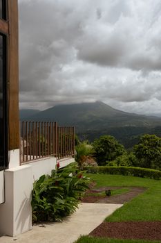 Luxurious backyard with mountain view under dramatic skies, perfect for nature retreats.