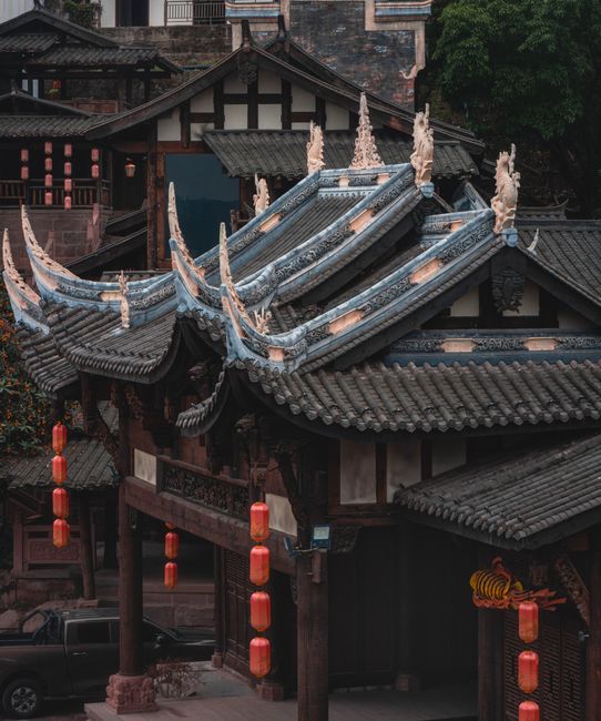 A beautiful traditional Asian temple with exquisite wooden architecture and hanging red lanterns.