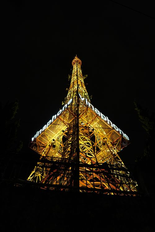 Free A striking low-angle shot of a brightly lit tower at night, showcasing architectural beauty. Stock Photo