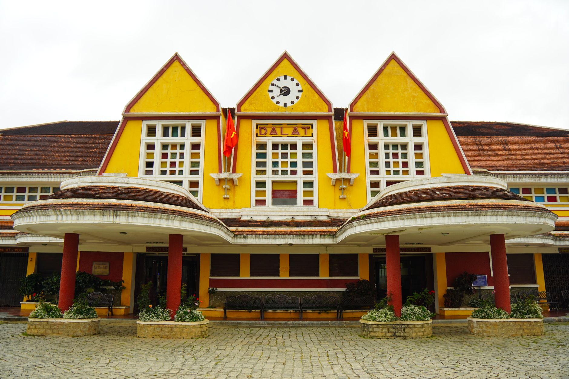 The vibrant yellow facade of Dalat Railway Station, showcasing its unique architectural style.
