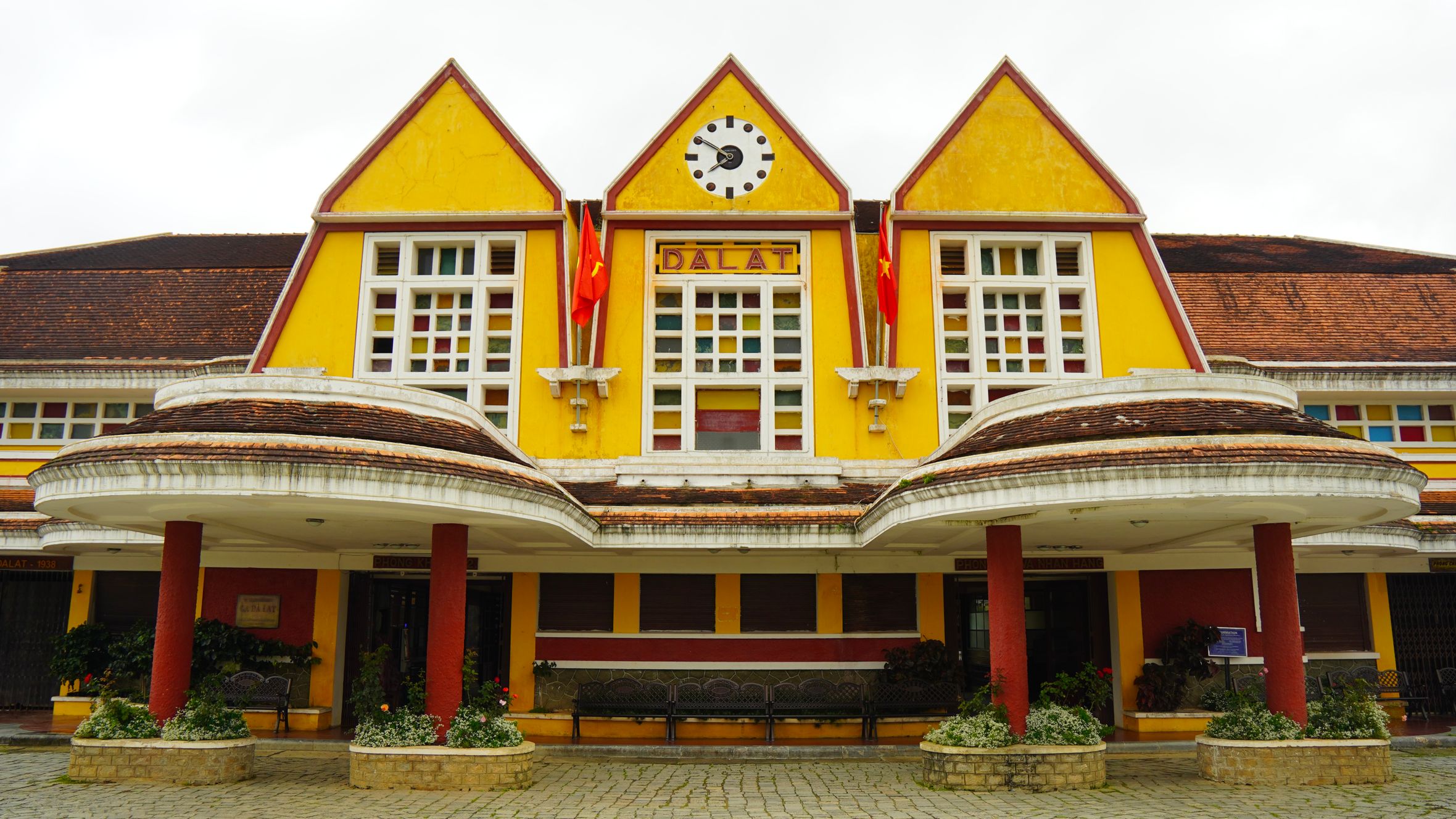 The vibrant yellow facade of Dalat Railway Station, showcasing its unique architectural style.