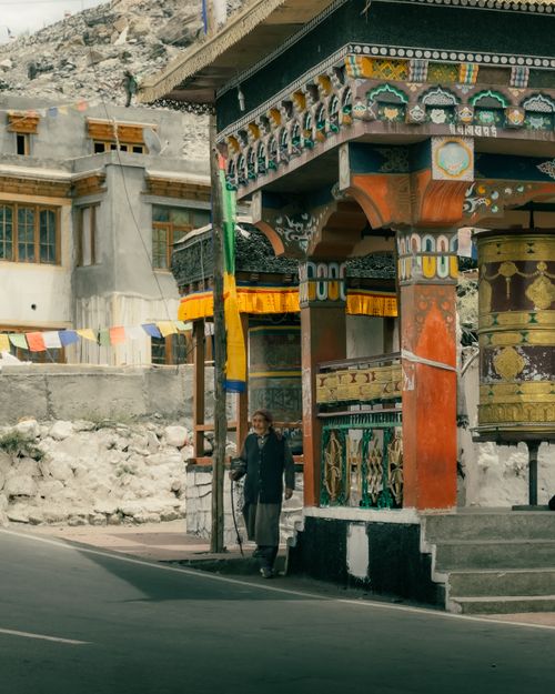 Free Traditional prayer wheel structure with vibrant colors in Diskit, Ladakh, surrounded by mountainous terrain. Stock Photo