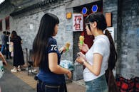 Two Women Enjoying Ice Cream on a Street