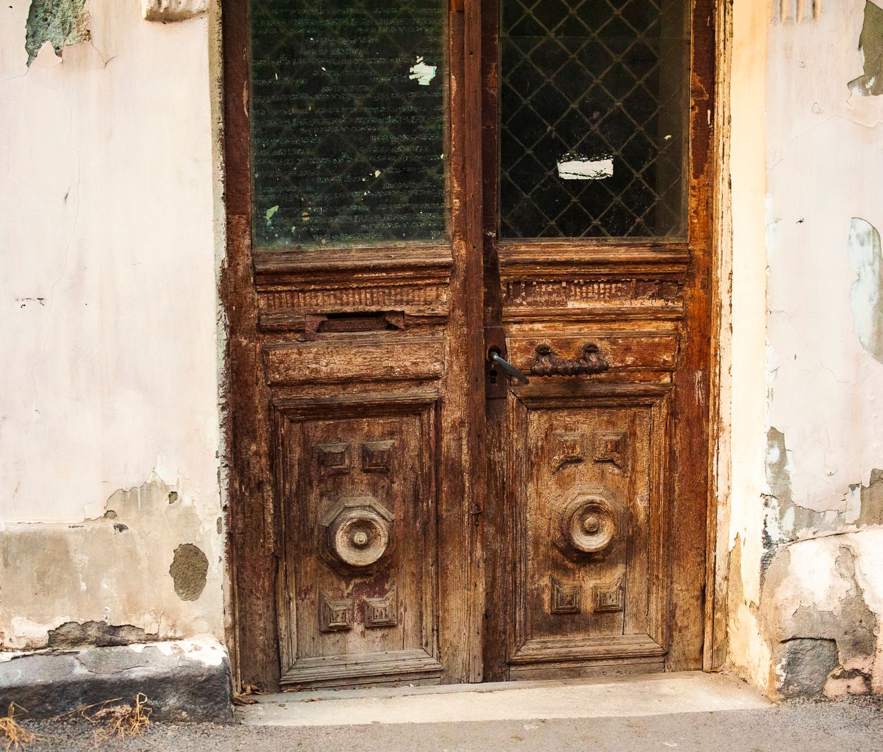 aged wooden door with intricate carvings in a rustic urban environment
