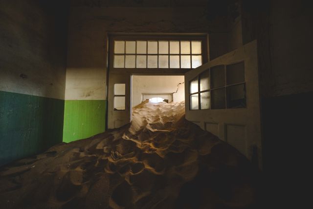 Sand dunes filling the rooms of an abandoned desert house — photo by Francesco Ungaro on Pexels