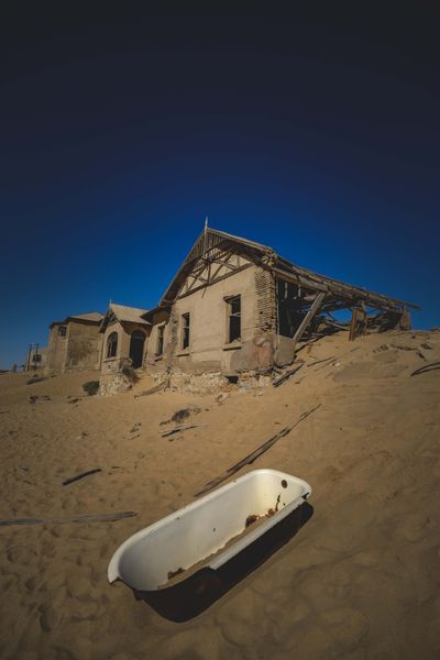 Abandoned house half-buried in sand, photo by Francesco Ungaro on Pexels